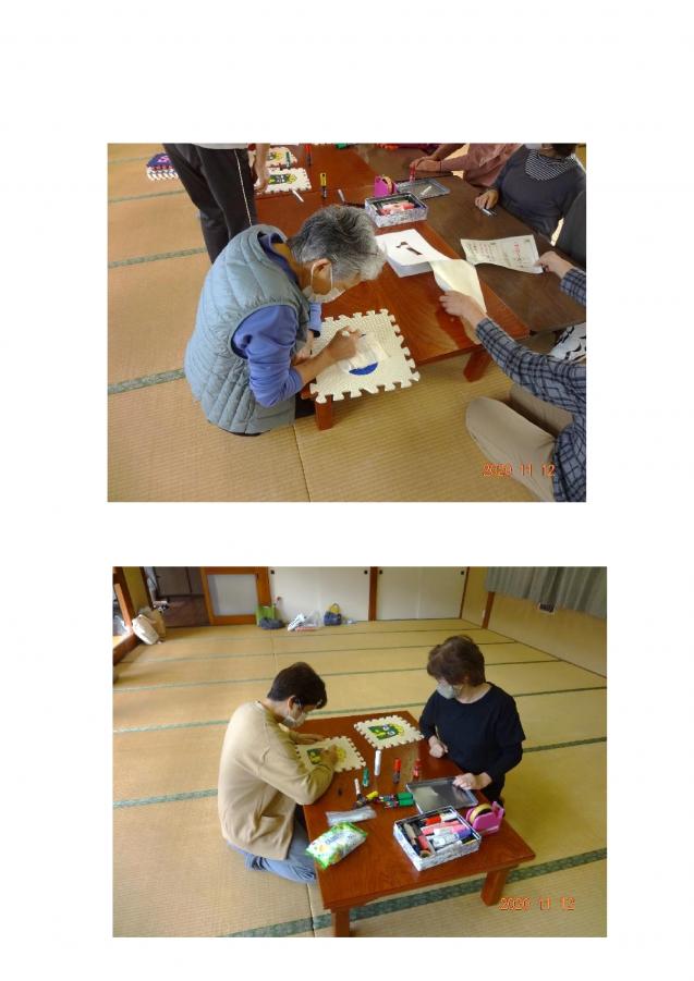 メンバーらが熱心にマットに描いている様子の写真
